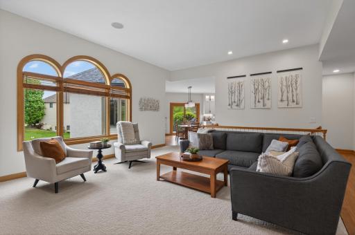 Bright living room with soaring ceilings and open sightlines to the kitchen.