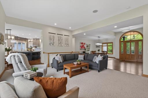 Open-concept living spaces with large windows and neutral finishes.