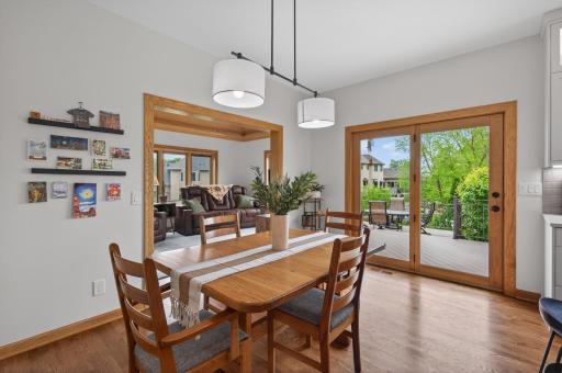 Bright dining space with sliding doors to the maintenance-free deck and sunroom access.