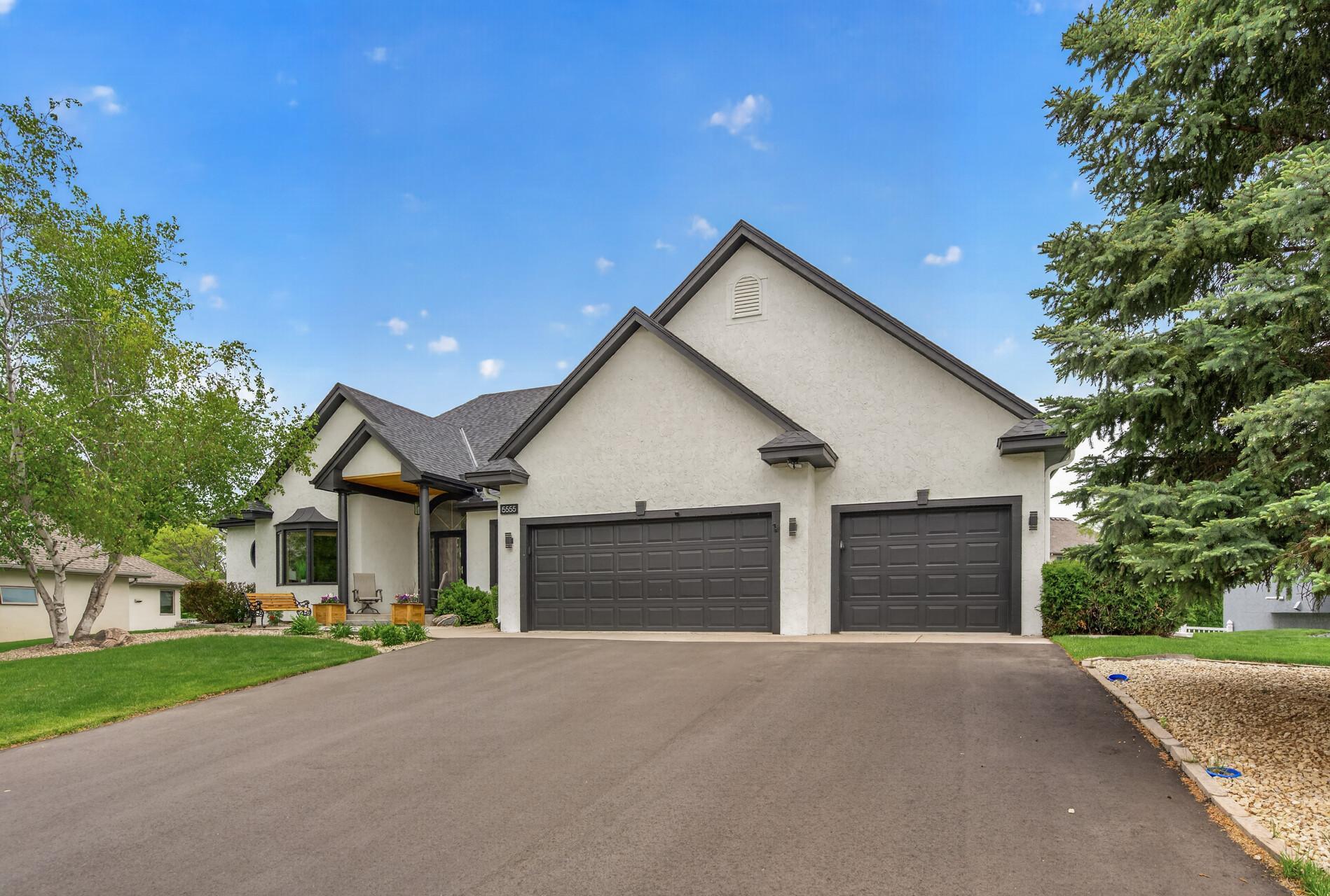 Welcoming curb appeal with oversized 3-car garage and covered front entry.
