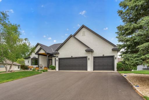 Welcoming curb appeal with oversized 3-car garage and covered front entry.
