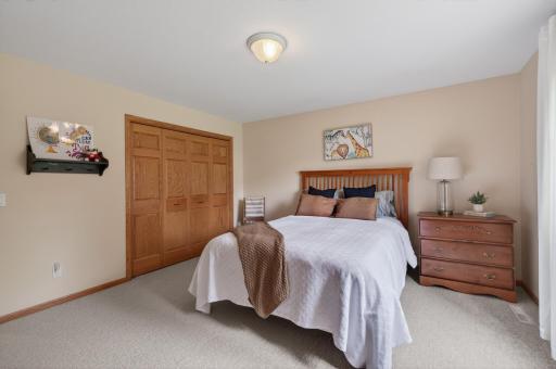 Bright secondary bedroom featuring oversized closet and soft neutral dÃ©cor.
