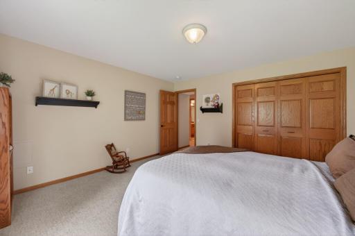 Spacious bedroom with double closet doors and flexible layout options.
