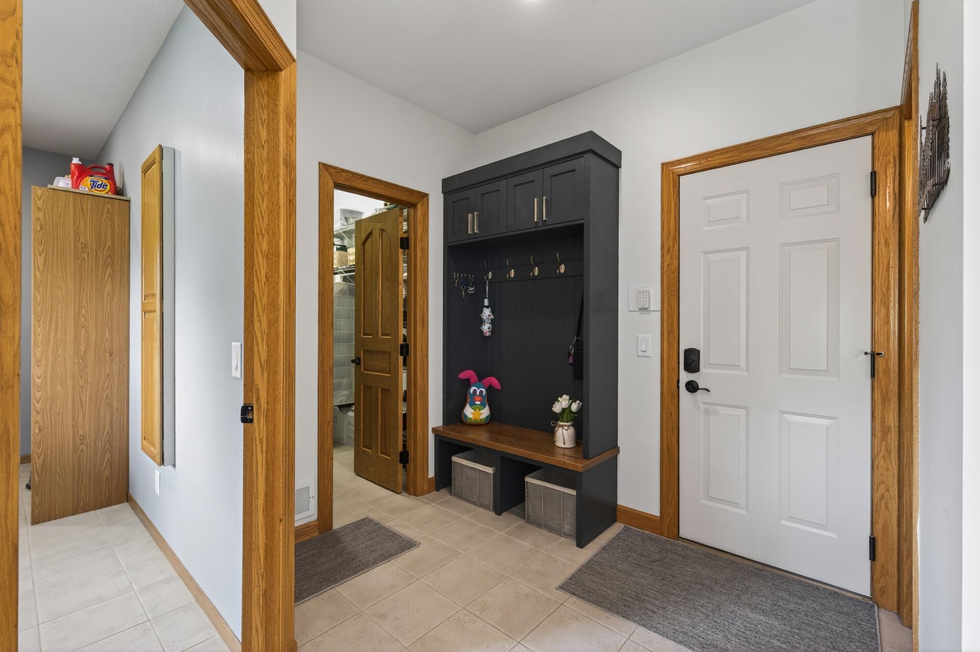 Updated mudroom entry with built-in bench, hooks, and convenient storage.