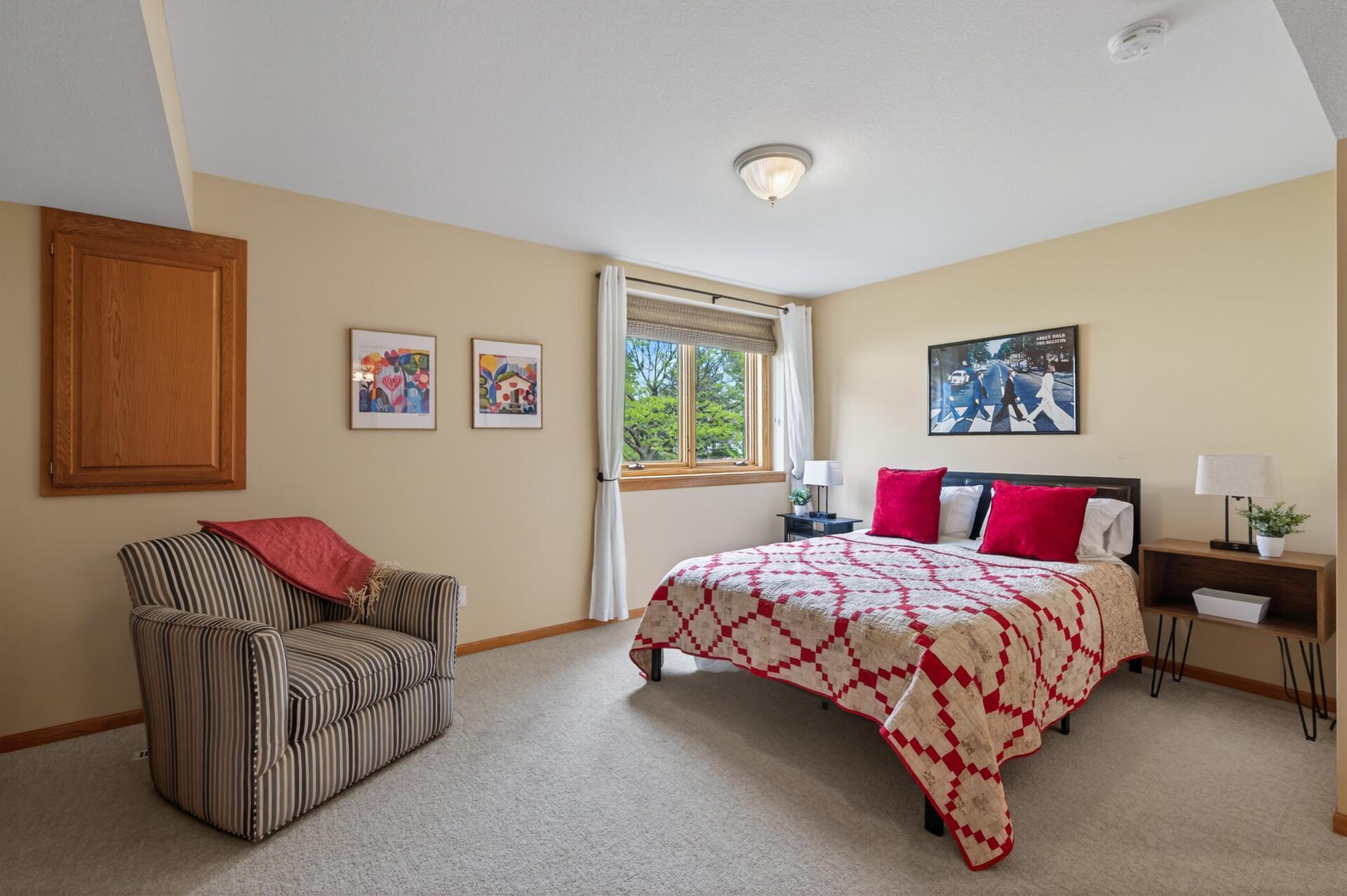 Large secondary bedroom with neutral décor and adjoining bath access.
