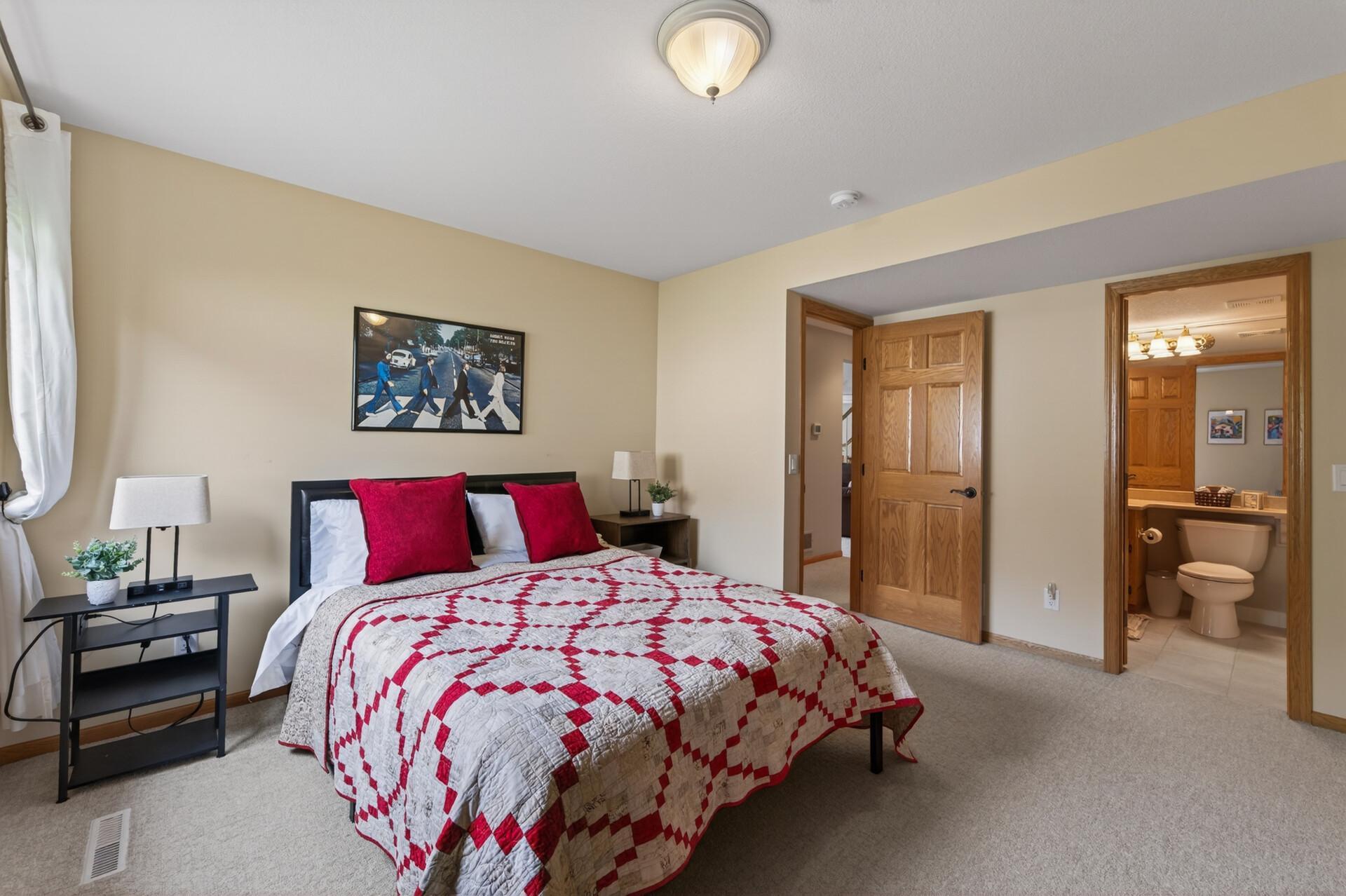 Secondary bedroom with abundant natural light and convenient walk-through bath access.