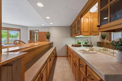 Entertainerâs wet bar with extensive cabinetry, prep sink, and serving space.