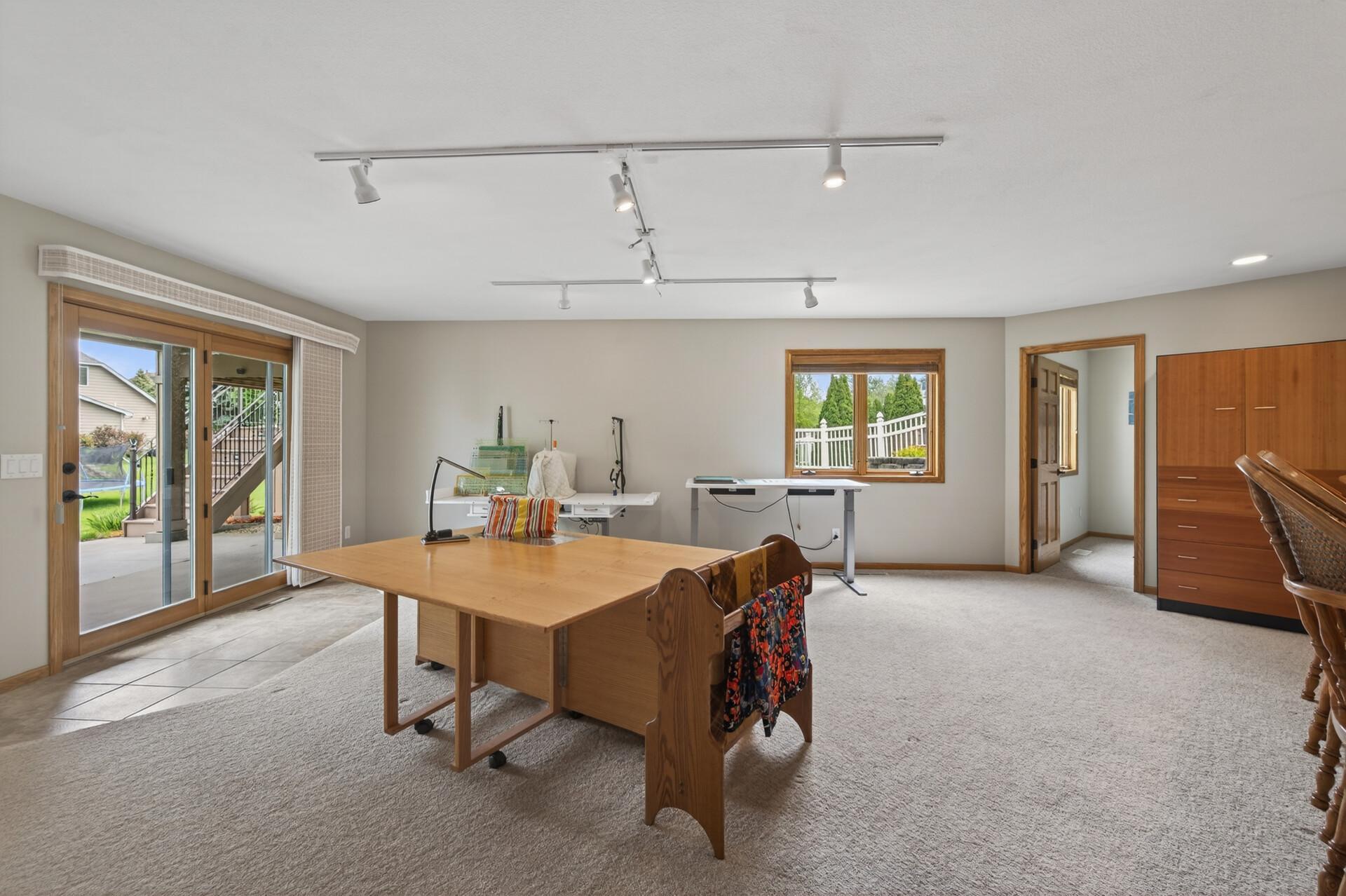 Spacious lower-level flex area with walkout patio access and room for crafts, exercise, or entertaining.
