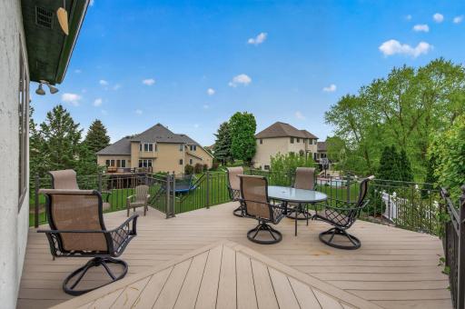 Spacious maintenance-free deck overlooking the private backyard and surrounding greenery.