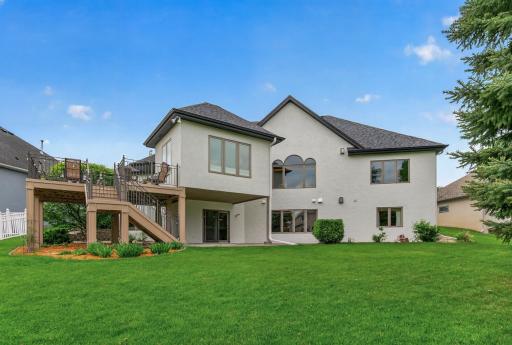 Beautiful walkout rambler with expansive maintenance-free deck and manicured backyard setting.