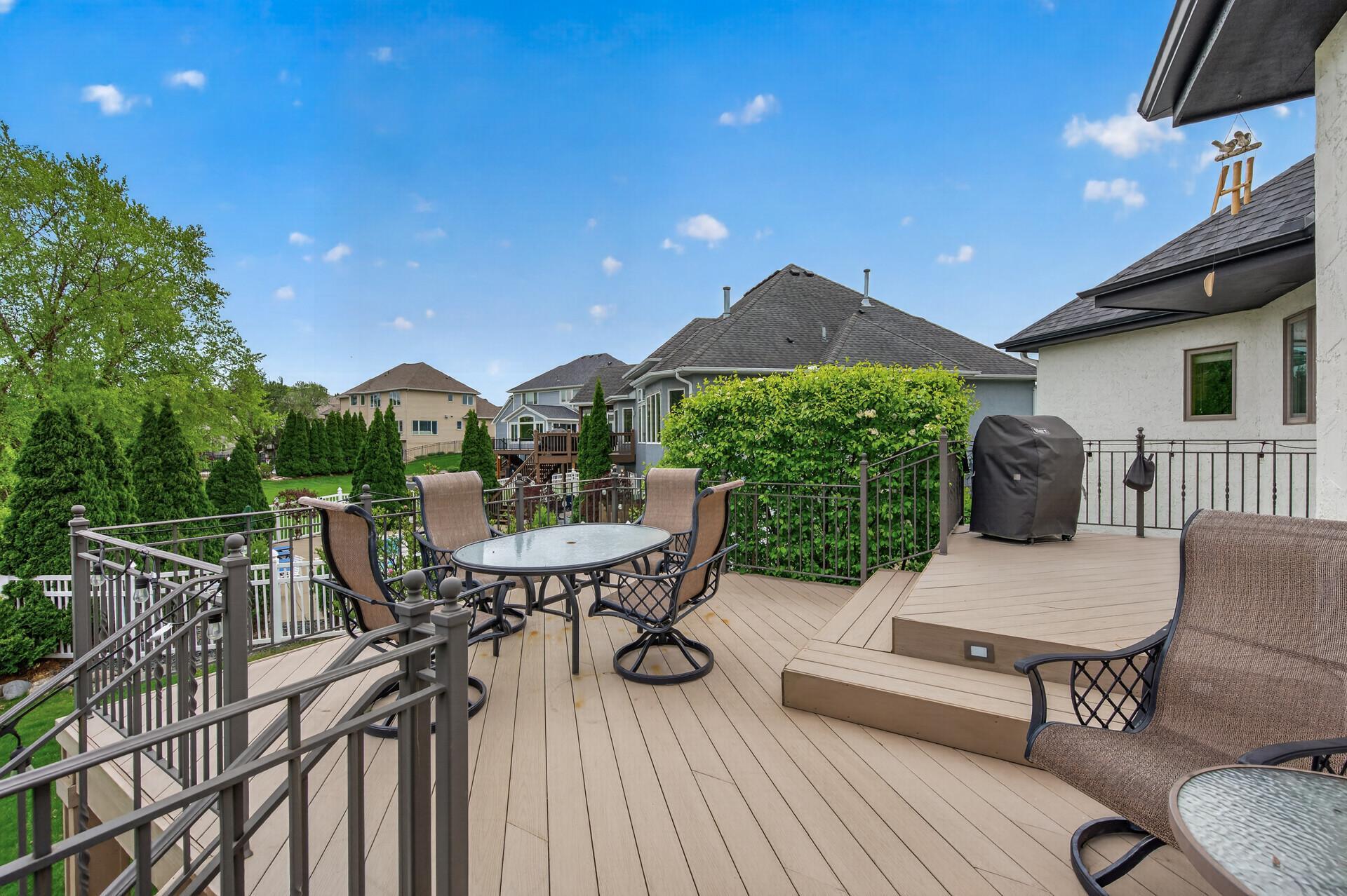 Maintenance-free deck with multiple seating areas and elevated backyard views.