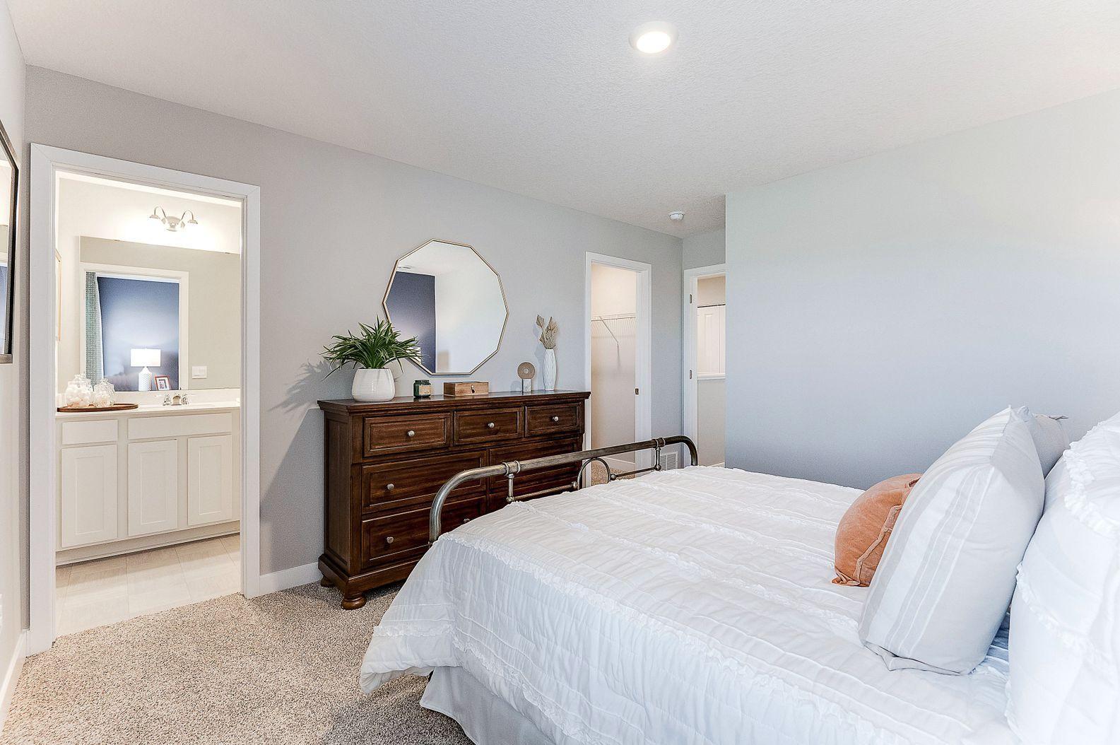 The primary bedroom suite overlooks the large backyard. (Model photo, colors may vary)