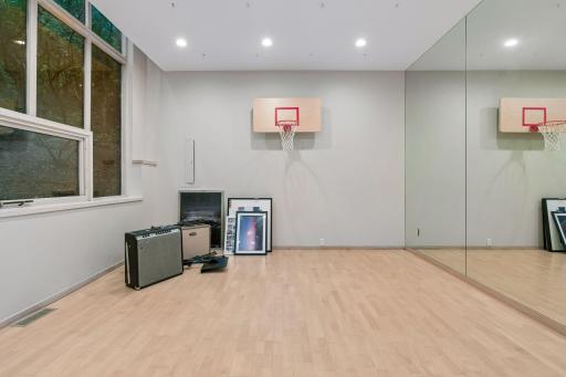 Bright, multi-functional recreation room on the second floor with a mirrored wall.