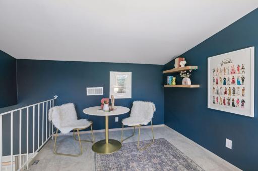 Charming sitting area with a bold accent wall in the loft space.