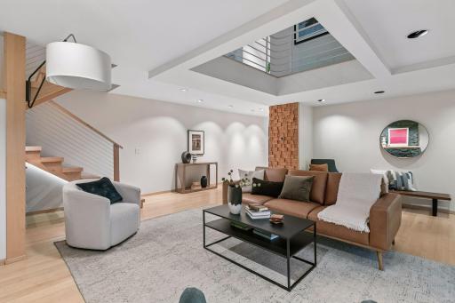Open living area blends comfortable gathering spaces with warm natural materials.