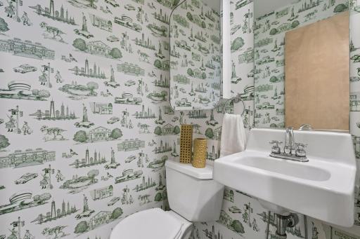 Fun, distinctive powder room with statement wallpaper.