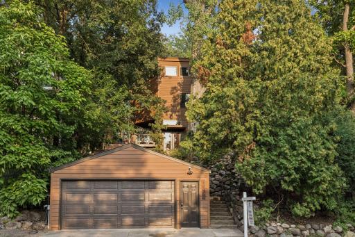 Private, wooded setting with landscaped grounds and an oversized detached garage.