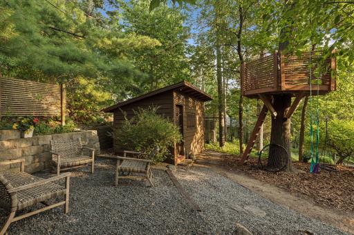 Private wooded retreat with a custom sauna, a treehouse, and an inviting outdoor seating area.