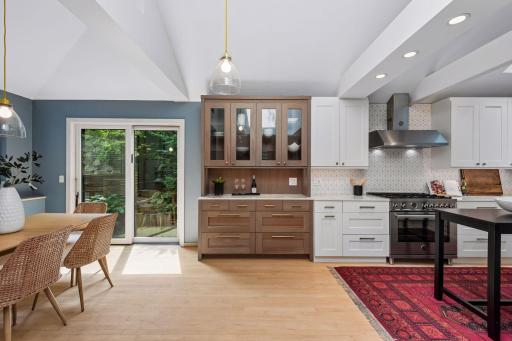 Bright, modern kitchen with custom cabinetry, quartz countertops and geometric tile backsplash.