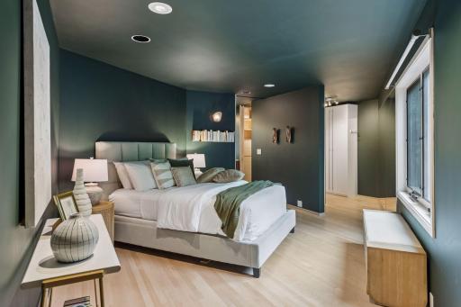 Spacious primary bedroom with serene, modern finishes.