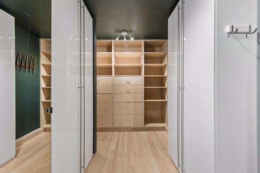 Custom-designed walk-in closet with abundant storage.