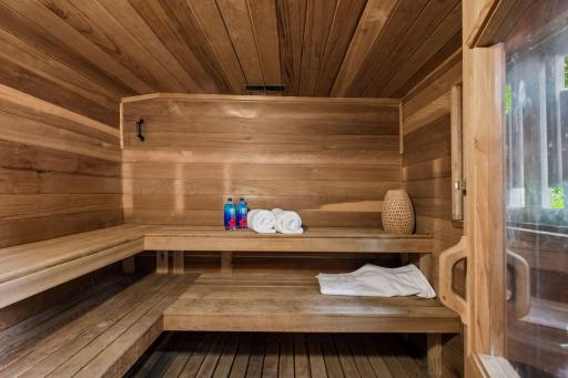 Thoughtfully designed sauna with cedar walls, built-in seating, and views of the surrounding woods.