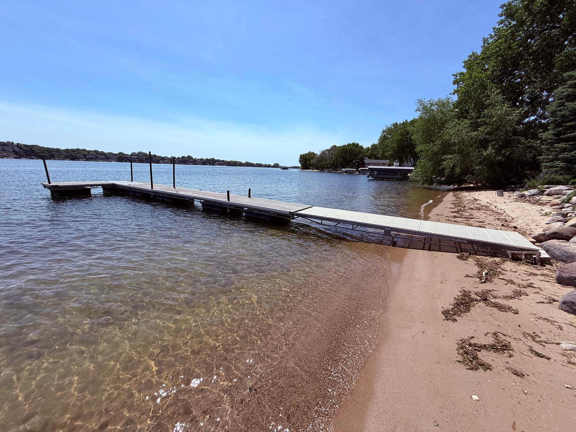 Sandy shoreline and beach with dock