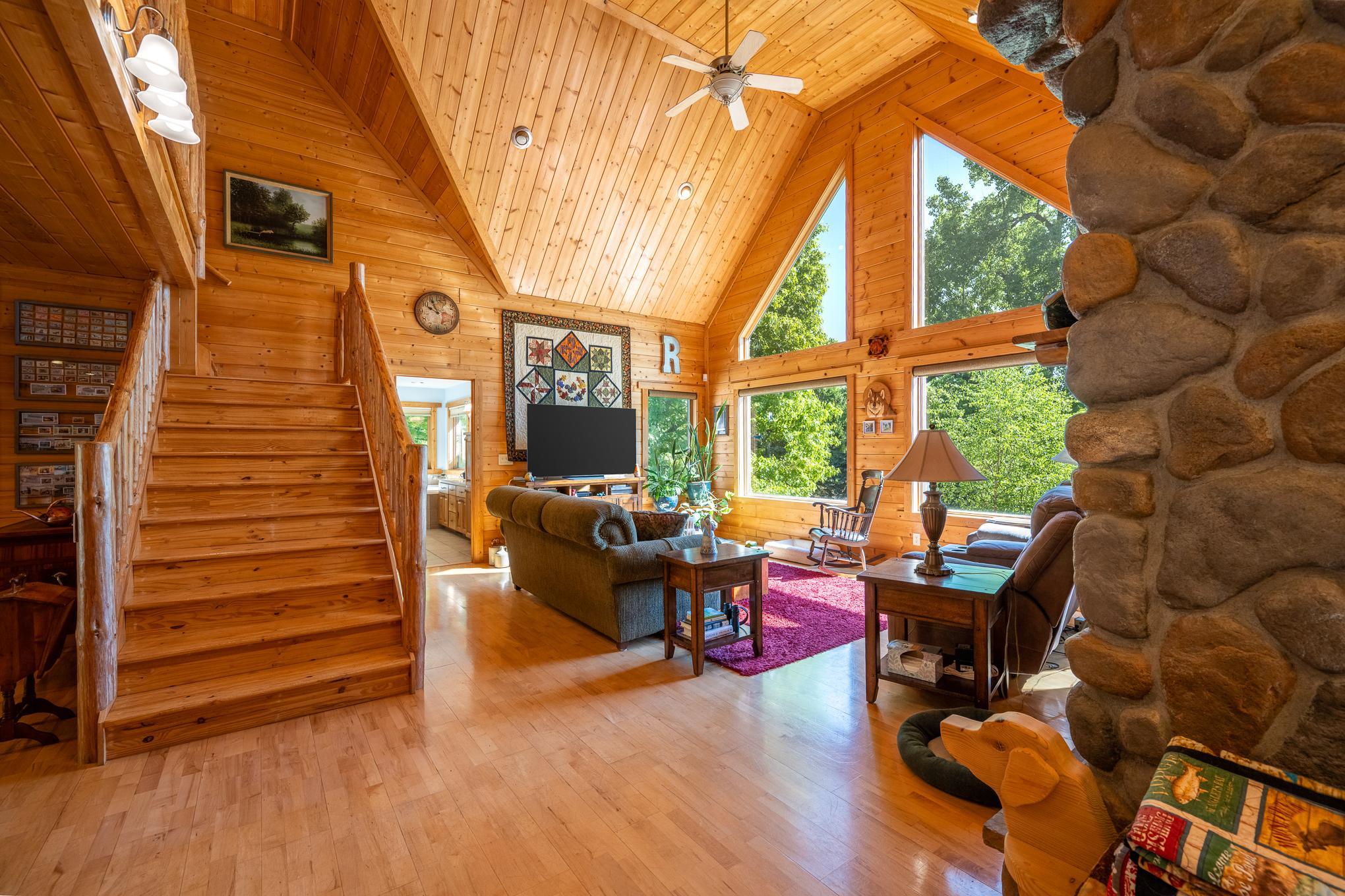 view from the kitchen to the living room and stairs to the loft