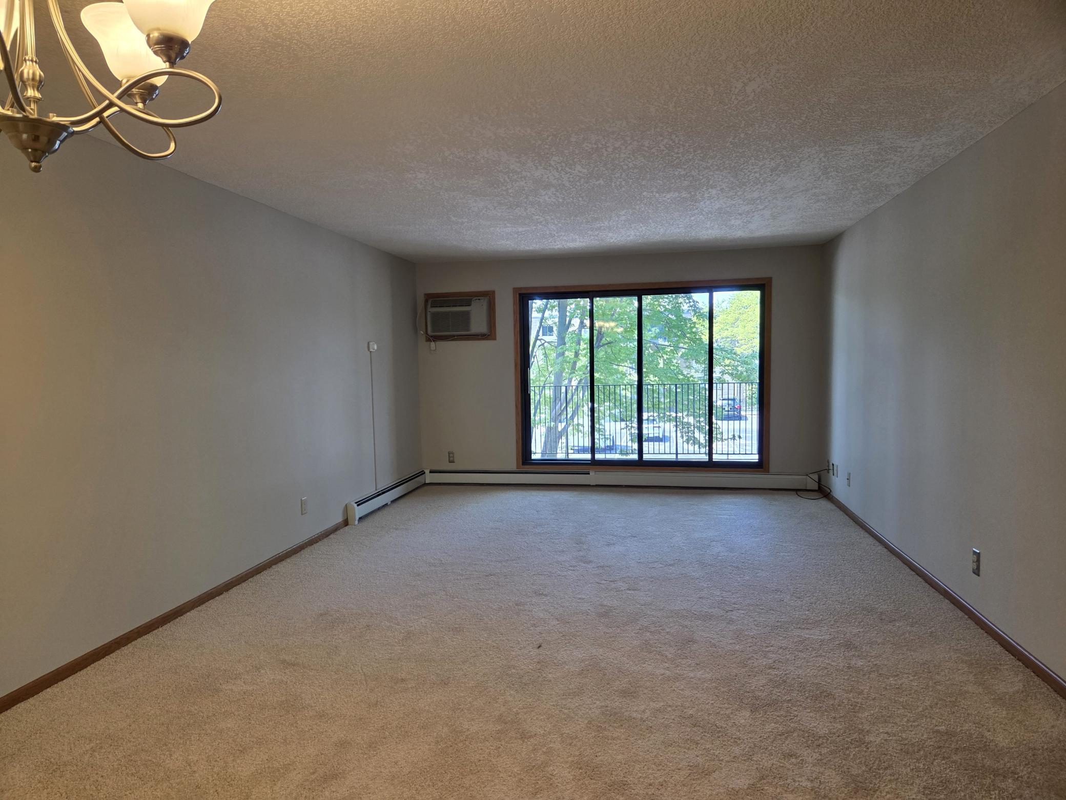 Enter into dining & living room with patio doors to deck. Notice the new paint and carpeting throughout!