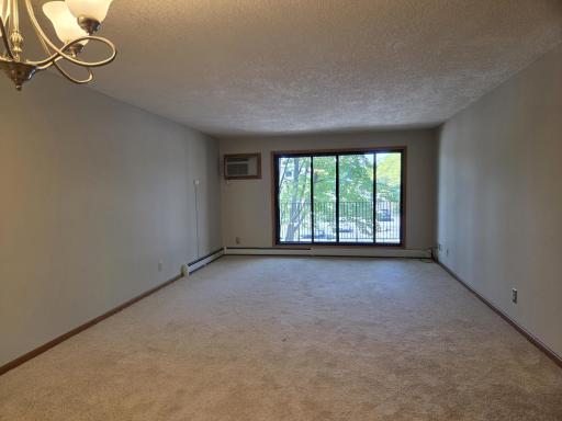 Enter into dining & living room with patio doors to deck. Notice the new paint and carpeting throughout!