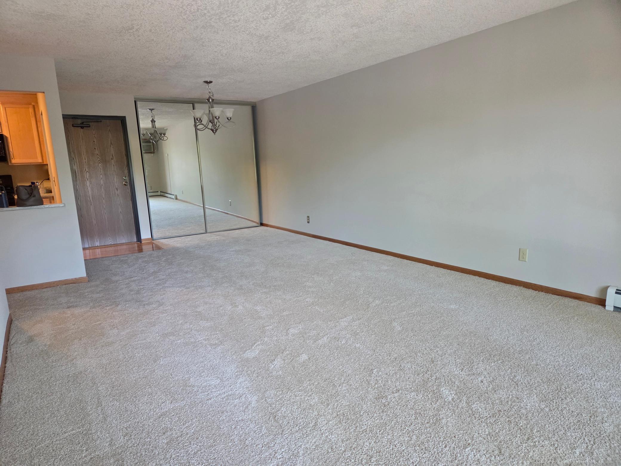 Laminate flooring inside the front door matches newer kitchen flooring also.