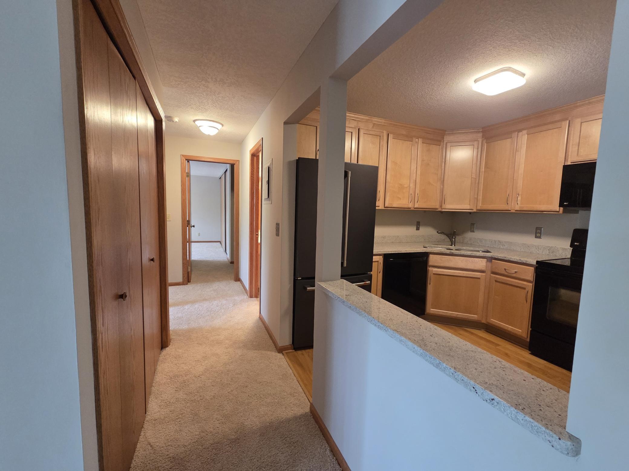 Main hall from the gathering areas to the three bedrooms. Once again- notice the newer carpet & paint!