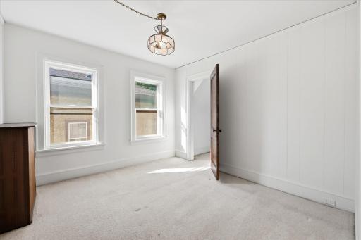 Two of three bedrooms on the upper level. Walk-in closet