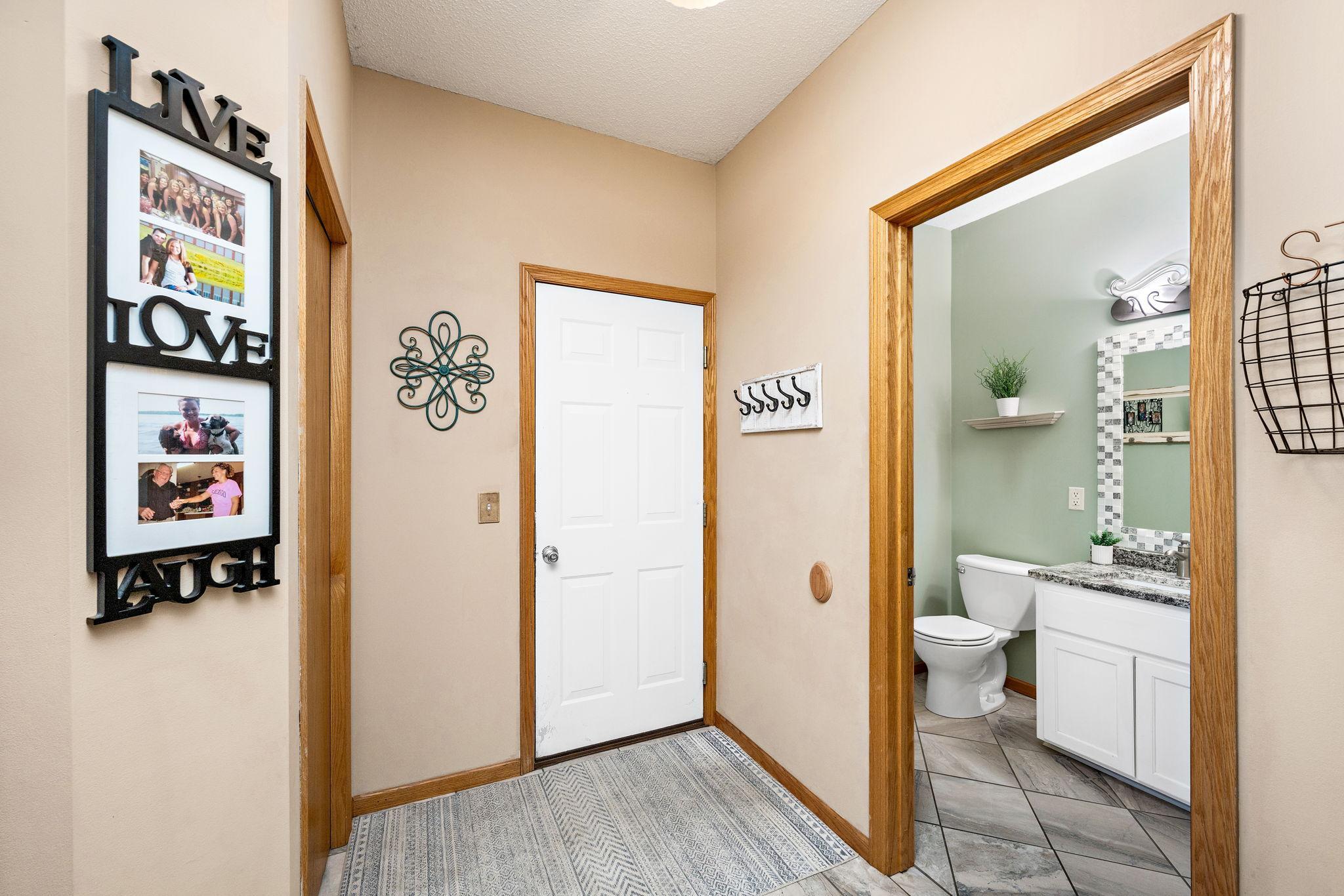 Back foyer has 1/2 bathroom, laundry room, and garage entry