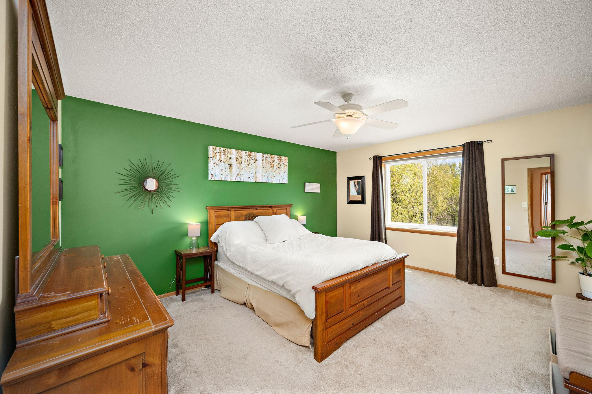 Primary bedroom suite overlooks private backyard