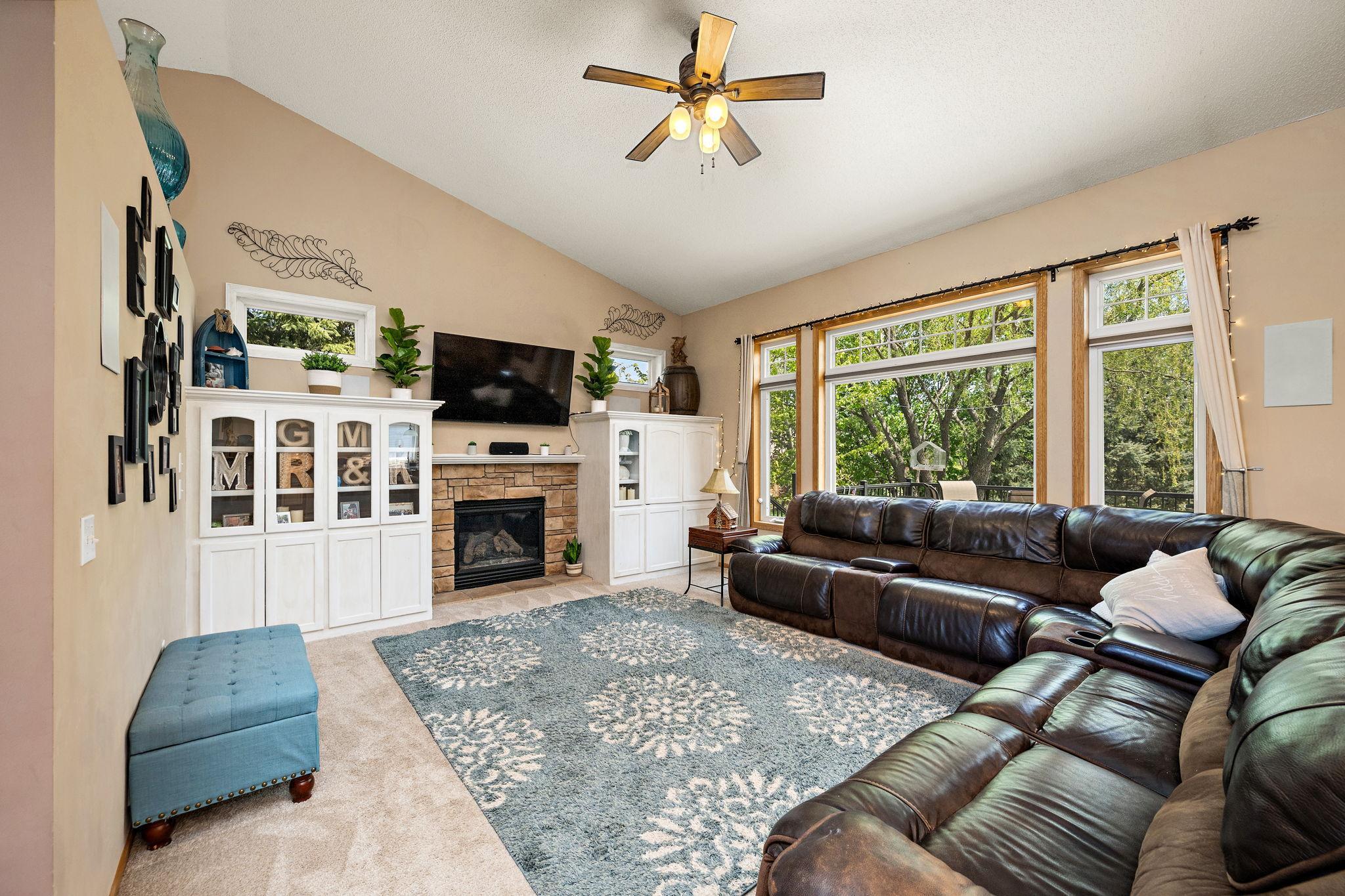 Living room with built-ins, gas fireplace, and large picture window