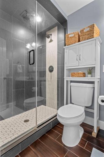 Private Â¾ bath showcasing a stunning tiled walk-in shower with rainfall shower head