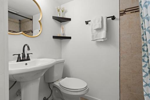 Beautifully updated Â¾ basement bathroom with elegant tile finishes