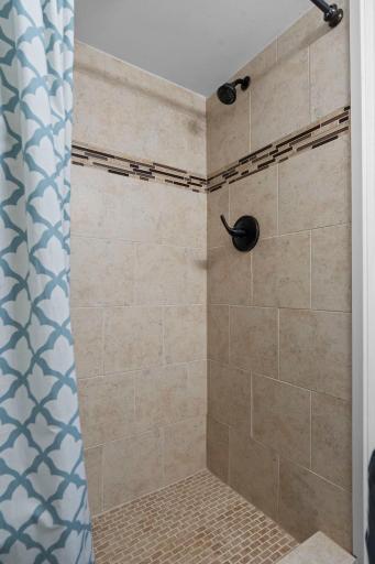 Beautifully updated Â¾ basement bathroom with elegant tile finishes