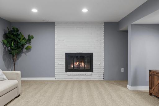 Retreat to the spacious finished lower level featuring a second brick fireplace, versatile living space, two additional bedrooms with egress windows, and a beautifully updated Â¾ bath with elegant tile finishes.