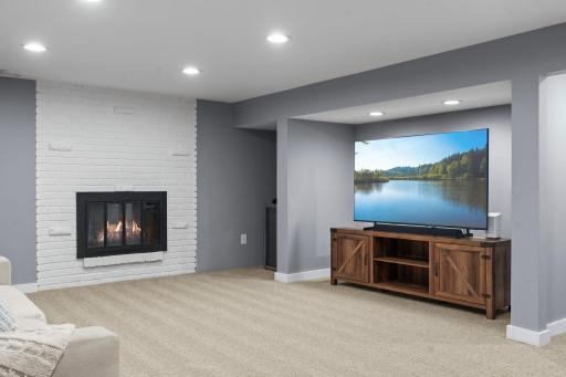 Stunning brick fireplace highlighted by brand new carpeting in the lower-level.