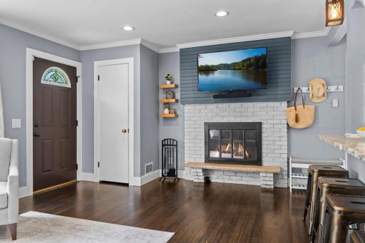 Stunning brick fireplace with tasteful shiplap accents.