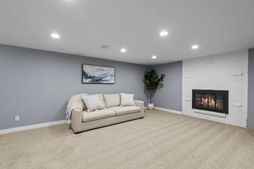 Retreat to the spacious finished lower level featuring a second brick fireplace, versatile living space, two additional bedrooms with egress windows, and a beautifully updated Â¾ bath with elegant tile finishes.