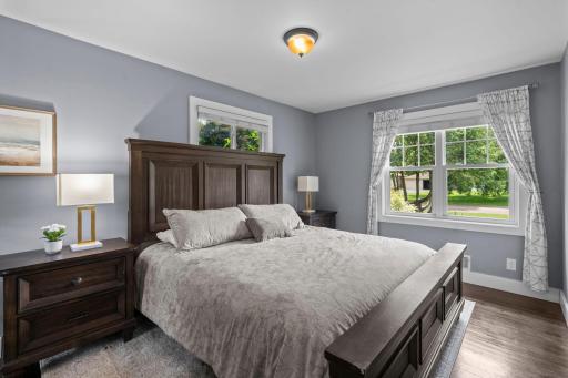 The main level offers a thoughtfully designed bedroom wing, highlighted by a serene primary suite with double windows and a private Â¾ bath showcasing a stunning tiled walk-in shower with rainfall shower head.