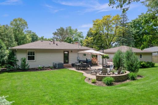A perfect backyard space for entertaining, recreation, or quiet evenings outside - Paver patio retreat, separate firepit area, expansive green space.