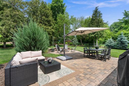 The tree-lined backyard is a true standout, featuring a paver patio retreat, separate firepit area, expansive green space âperfect for entertaining, recreation, or quiet evenings outside.
