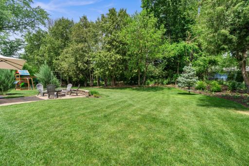 Private, tree-lined backyard, meticulous landscaping, and outstanding outdoor living spaces.