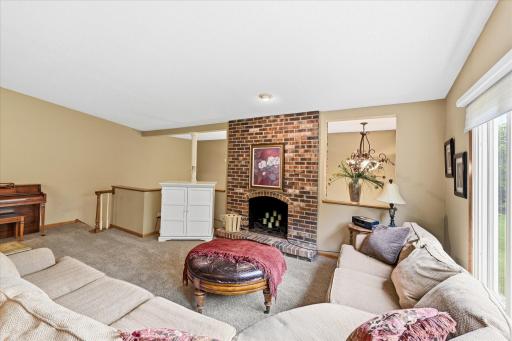 Large upper level living room with wood fireplace.