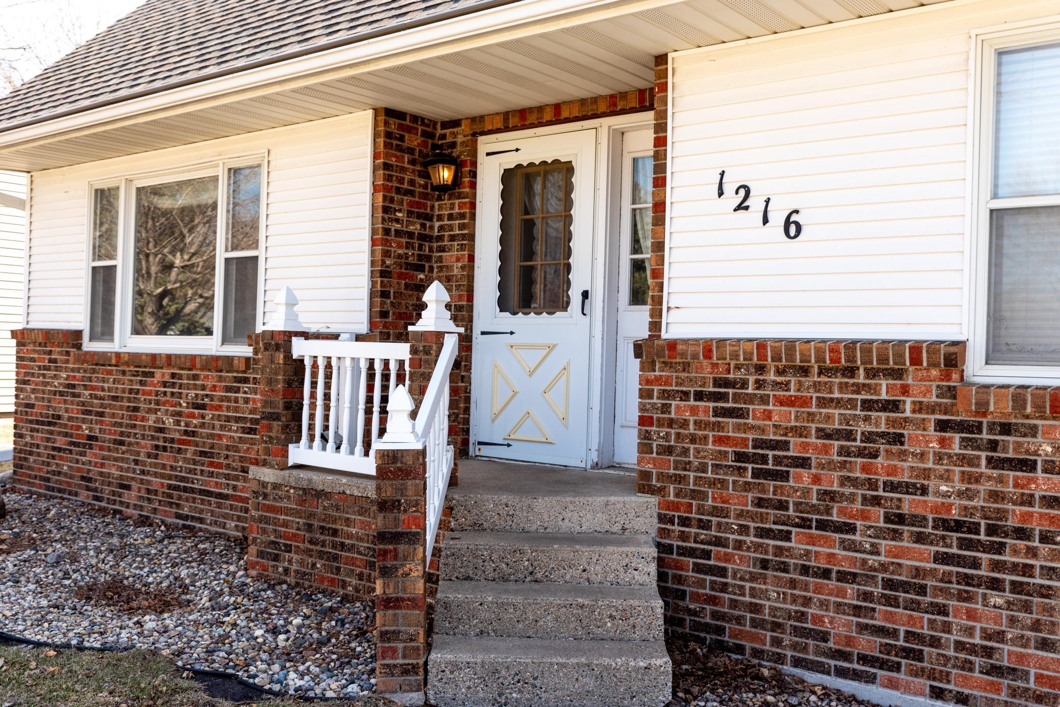 Custom built home offers great curb appeal with brick facade and angled front steps!