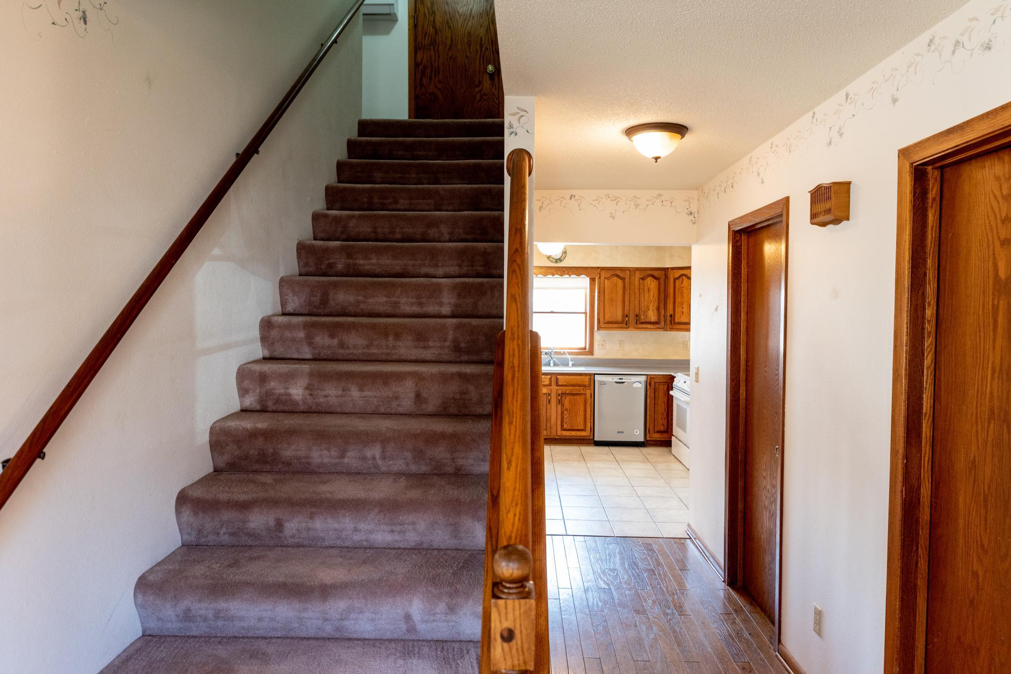 Plush carpeting on the steps & wood floor at front entry foyer enhance first impression.